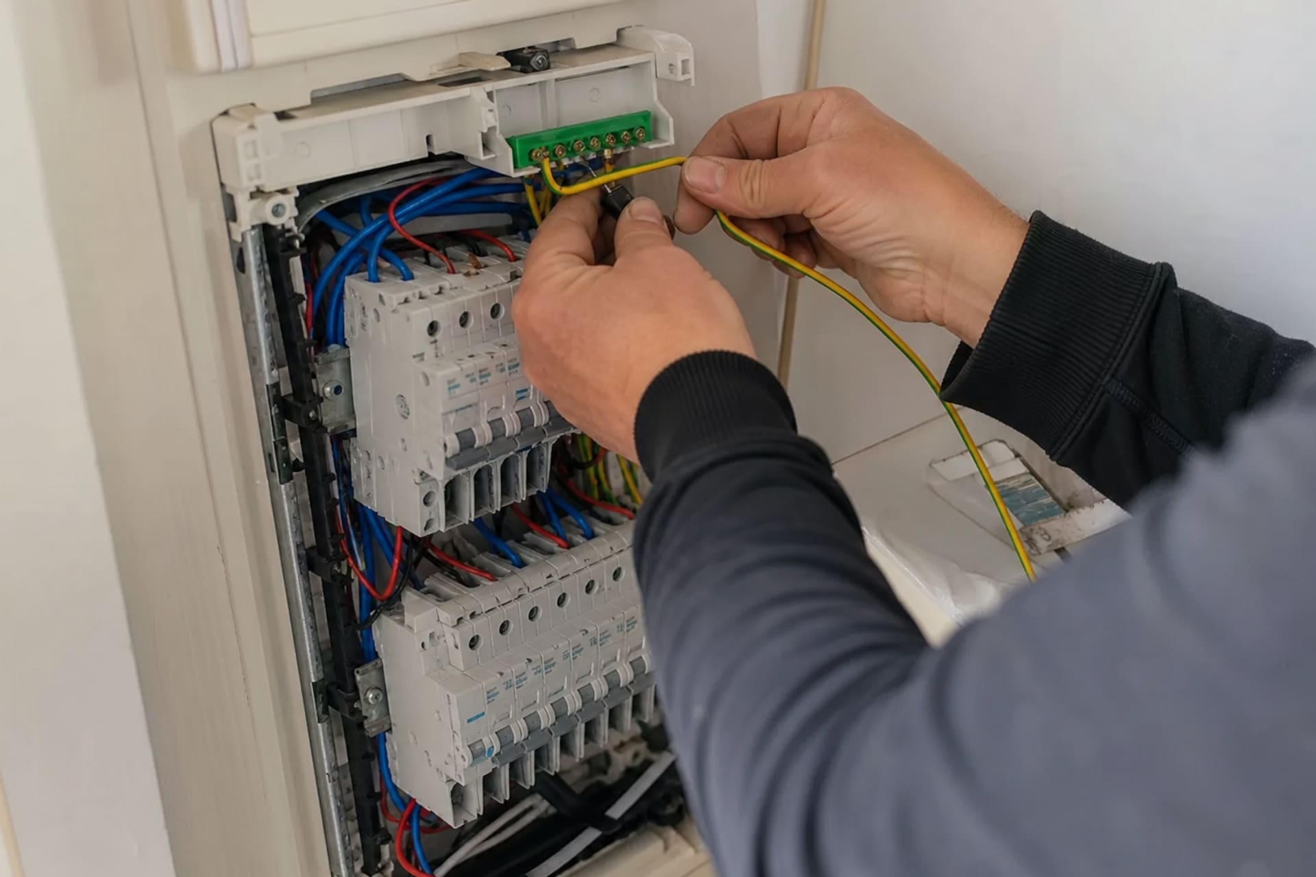 mains ajoutant conducteur terre pour mise aux normes